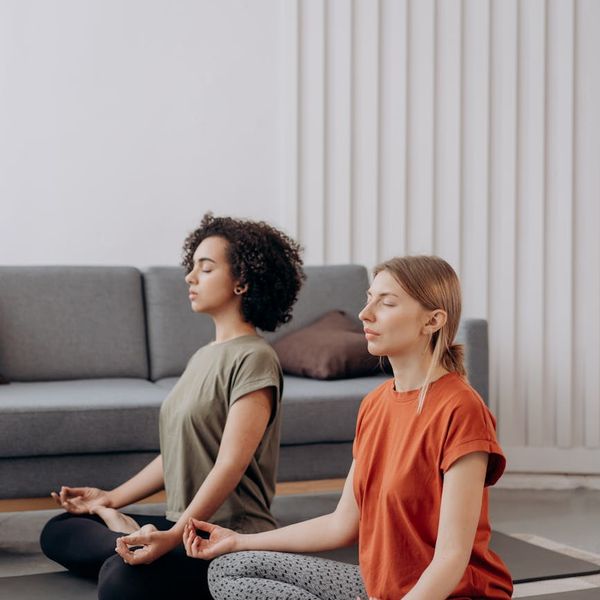 Person finding balance in a well-lit, minimalist room.